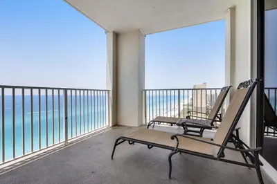a balcony with a bench and a view of the ocean at Ocean Reef 1709 in Panama City Beach