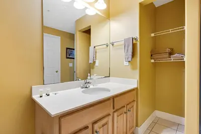 a bathroom with a sink and a mirror at Ocean Reef 1709 in Panama City Beach