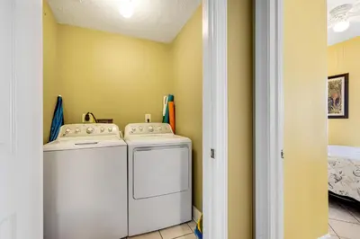 a laundry room with a washer and dryer at Ocean Reef 1709 in Panama City Beach