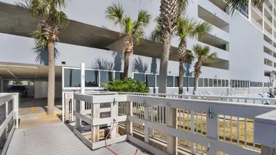 an exterior view of a building with palm trees at Ocean Reef 1709 in Panama City Beach
