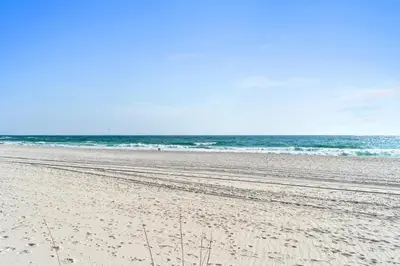a sandy beach with the ocean in the background at Harbur Arms - Pet Friendly in Panama City Beach