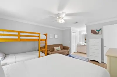 a bedroom with a bed and a ceiling fan at Harbur Arms - Pet Friendly in Panama City Beach