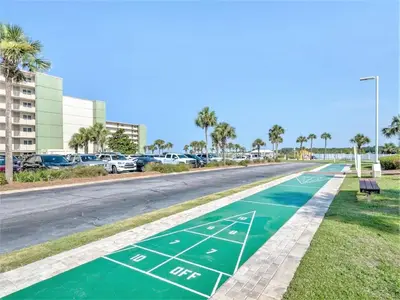 a street with a green basketball court on it at Pinnacle Port Beach Resort in Panama City Beach