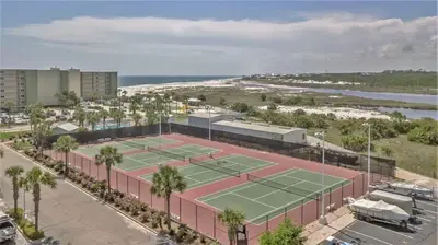 an aerial view of a tennis court next to the beach at Pinnacle Port Beach Resort in Panama City Beach
