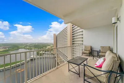 a balcony with chairs and a view of a river at Laketown Wharf 1331 in Panama City Beach