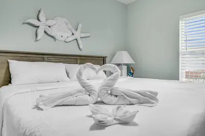 a bed with two swans made out of towels at Laketown Wharf 1331 in Panama City Beach