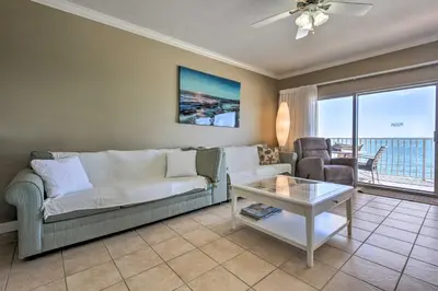 a living room with a couch and a table at Gulf Views and Pool Access Coral Reef Resort Condo in Panama City Beach
