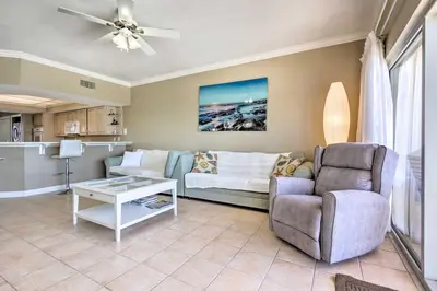 a living room with a couch and a chair at Gulf Views and Pool Access Coral Reef Resort Condo in Panama City Beach