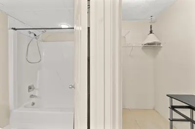 a white bathroom with a shower with a tub at Aquavista 405e in Panama City Beach