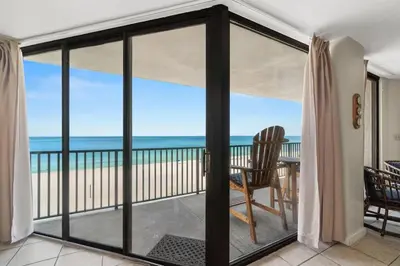 a room with a balcony with a view of the ocean at Aquavista 405e in Panama City Beach