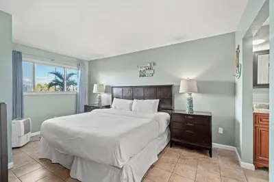 a bedroom with a large white bed and a window at The Summit 105 in Panama City Beach