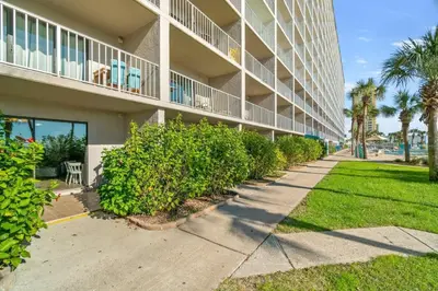 a building with a sidewalk in front of it at The Summit 105 in Panama City Beach