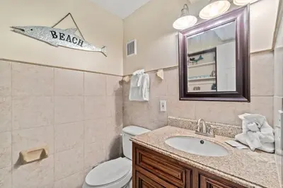 a bathroom with a sink and a fish sign on the wall at The Summit 105 in Panama City Beach