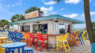 a bar with colorful chairs and tables on the beach at The Summit 1116 in Panama City Beach