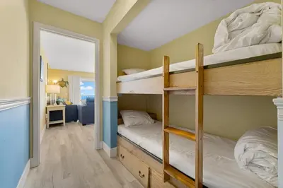 a bedroom with two bunk beds and a hallway at The Summit 1116 in Panama City Beach