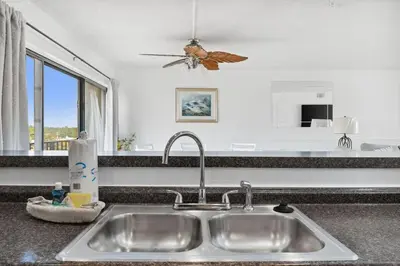 a kitchen counter with a sink and a window at Moondrifter 608 in Panama City Beach