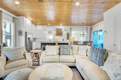 a living room with a couch and a table at Aqua Blue in Inlet Beach