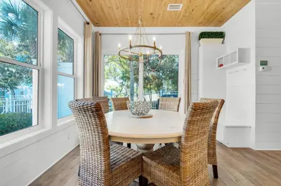 a dining room with a table and chairs at Aqua Blue in Inlet Beach