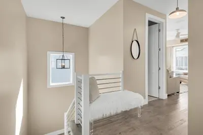 a white room with a white chair in it at Aqua Blue in Inlet Beach