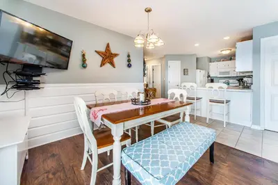 a kitchen and dining room with a table and chairs at Beachside Villas 332 in Santa Rosa Beach