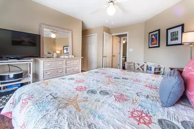a bedroom with a large bed and a television at Beachside Villas 332 in Santa Rosa Beach