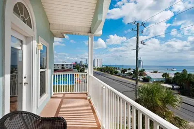 a balcony of a house with a view of the ocean at Vista del Mar I Ocean Overlook 302 in Panama City Beach