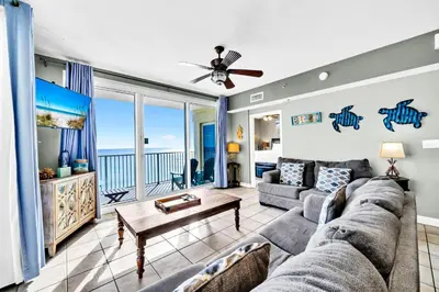 a living room with a couch and a table at Shores of Panama 1003 in Panama City Beach