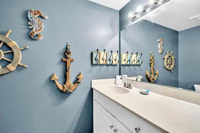 a bathroom with a sink and a mirror at Shores of Panama 1003 in Panama City Beach