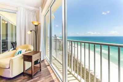 a living room with a balcony with the ocean at Boardwalk 1502 in Panama City Beach
