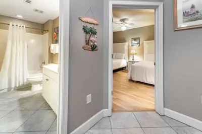 a hallway with a bathroom and a bedroom at Tidewater 502 in Panama City Beach