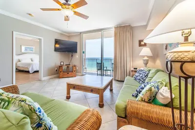 a living room with a couch and a tv at Tidewater 502 in Panama City Beach