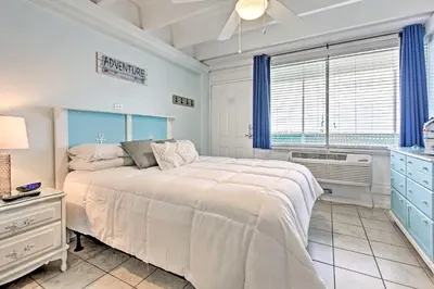 a bedroom with a large bed and a window at Panama City Beach Studio with Pool and Beach Access in Panama City Beach