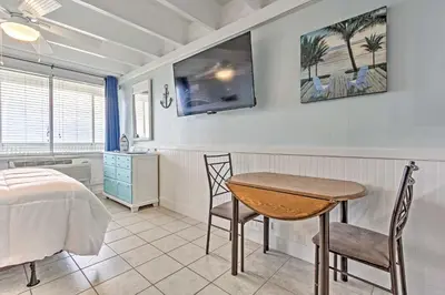 a bedroom with a table and chairs and a bed at Panama City Beach Studio with Pool and Beach Access in Panama City Beach