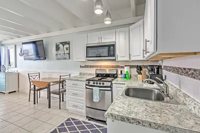 a kitchen with a sink and a stove top oven at Panama City Beach Studio with Pool and Beach Access in Panama City Beach