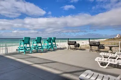 a row of chairs and tables on the beach at Panama City Beach Studio with Pool and Beach Access in Panama City Beach