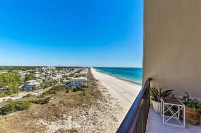 a balcony with a view of a beach and the ocean at PCB Beachfront Coastal Abode at Pinnacle Port! in Panama City Beach