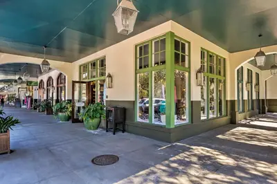 a building with green windows and a street with plants at PCB Beachfront Coastal Abode at Pinnacle Port! in Panama City Beach