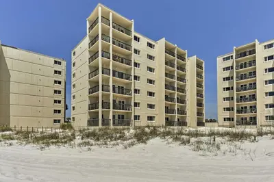 a row of apartment buildings on the beach at PCB Beachfront Coastal Abode at Pinnacle Port! in Panama City Beach