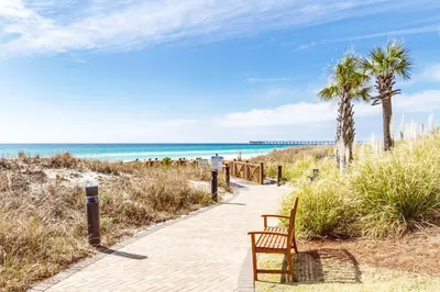 a bench on a path to the beach at Grand Panama 2-705 in Panama City Beach