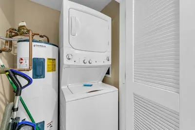 a washer and dryer next to a white refrigerator at Grand Panama 2-705 in Panama City Beach