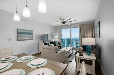 a living room with a table and a living room at Sterling Breeze 2006 in Panama City Beach