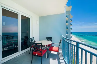 a balcony with a table and chairs and the ocean at Sterling Breeze 2006 in Panama City Beach