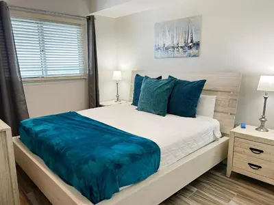 a bedroom with a large bed with blue pillows at Sterling Breeze 2006 in Panama City Beach