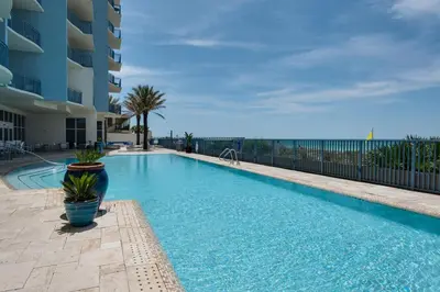 a swimming pool with a view of the ocean at Sterling Breeze 2006 in Panama City Beach