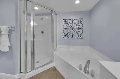 a white bathroom with a shower and a sink at Majestic Beach Towers 2-1206 in Panama City Beach