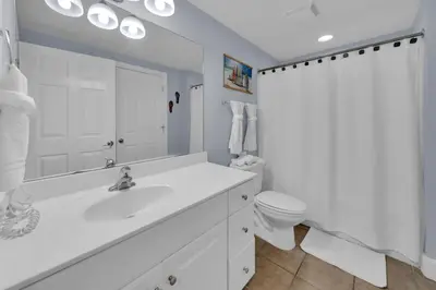 a white bathroom with a sink and a toilet at Majestic Beach Towers 2-1206 in Panama City Beach
