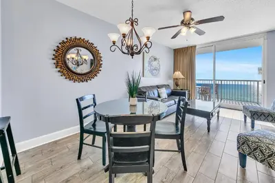 a dining room and living room with a view of the ocean at Majestic Beach Towers 2-1206 in Panama City Beach