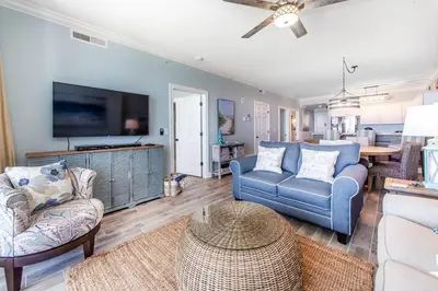 a living room with two chairs and a tv at Ocean Villa 1406 in Panama City Beach