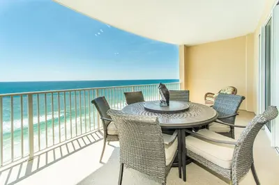 a balcony with a table and chairs and the ocean at Ocean Villa 1406 in Panama City Beach