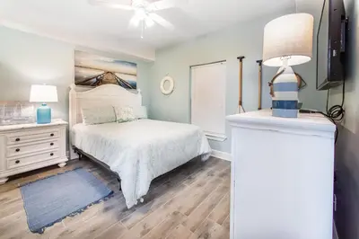 a bedroom with a bed and a dresser at Ocean Villa 1406 in Panama City Beach